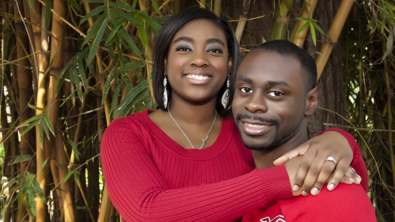 Engaged couple embracing among bamboo